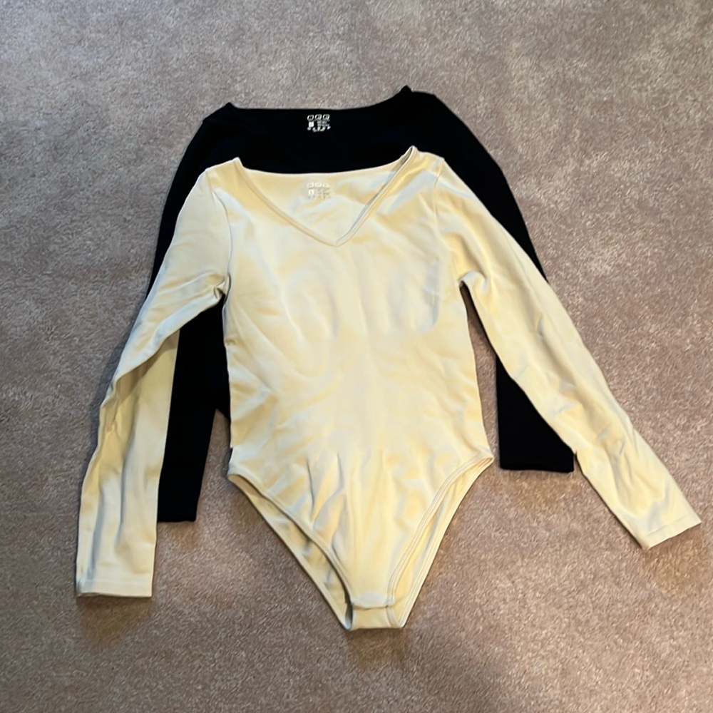 Set of 2 OQQ ribbed slimming bodysuits in black and white.